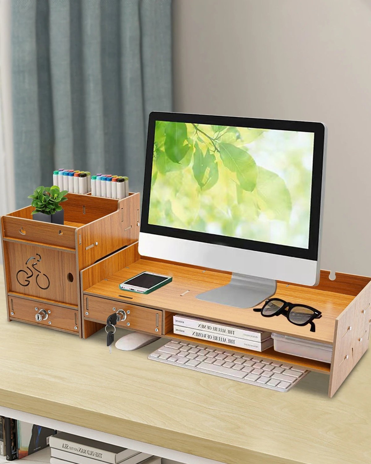 A two-tier wood monitor riser lifting a screen with the keyboard tucked underneath