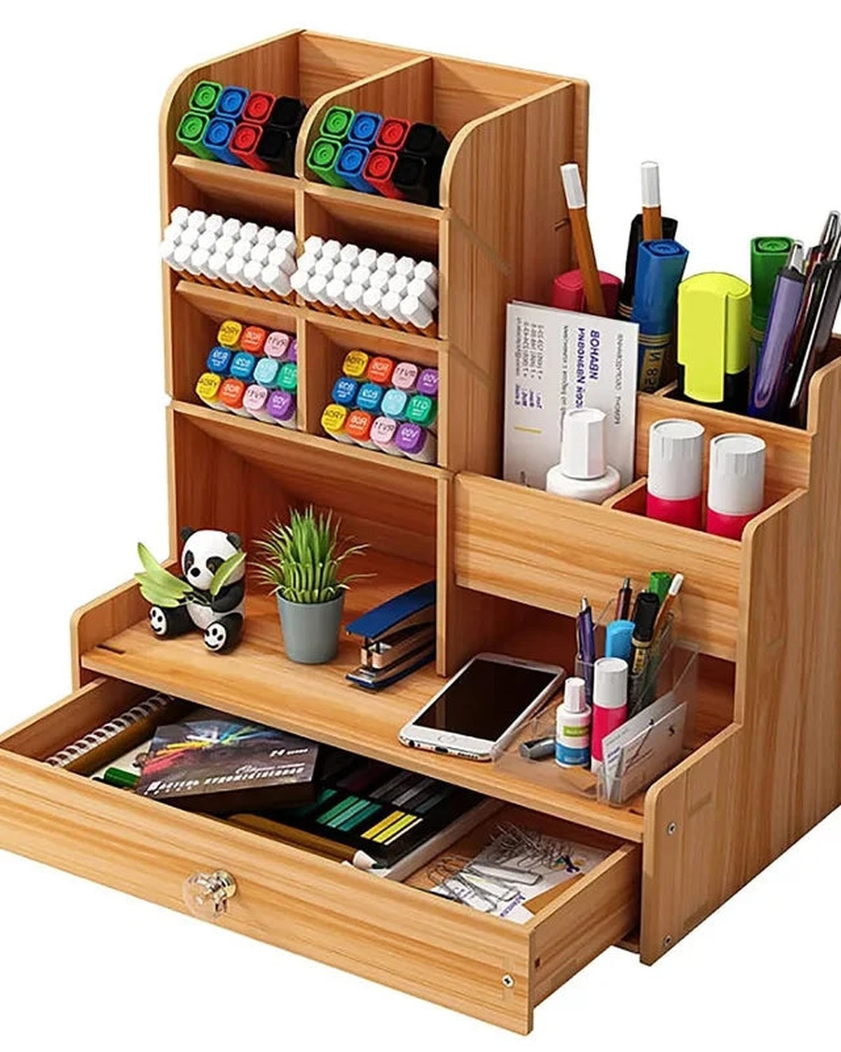 A wood desk organiser with pens, supplies and an open drawer